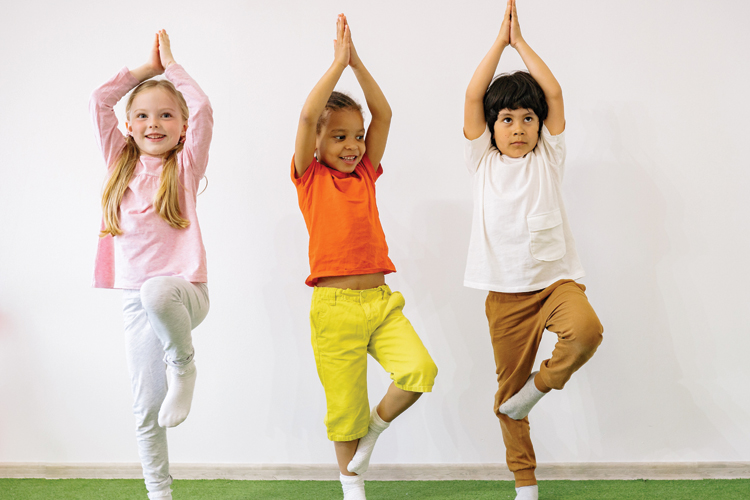Three kids practicing yoga