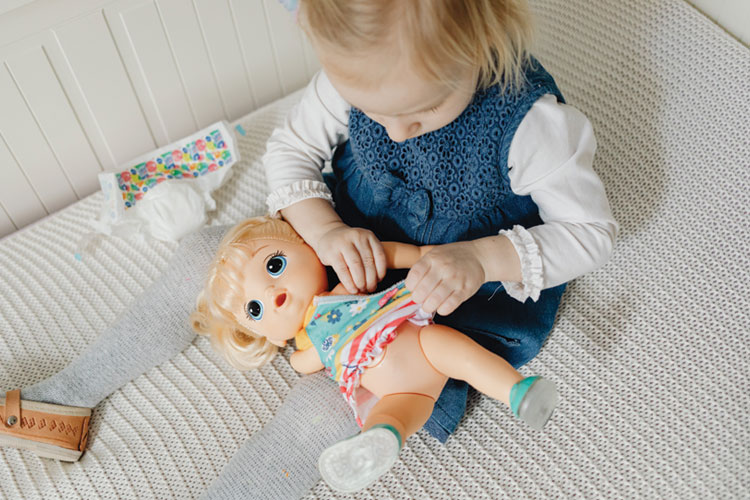 Small child playing doll