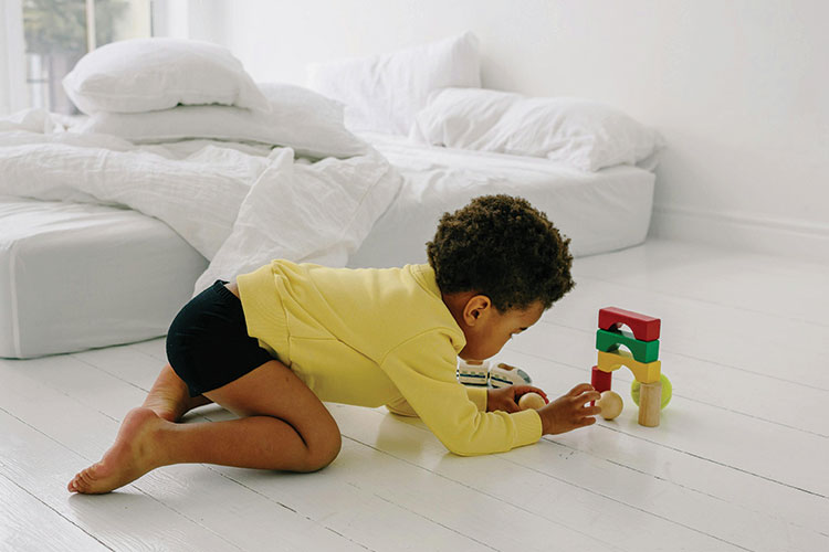 Small child playing with blocks on the floor