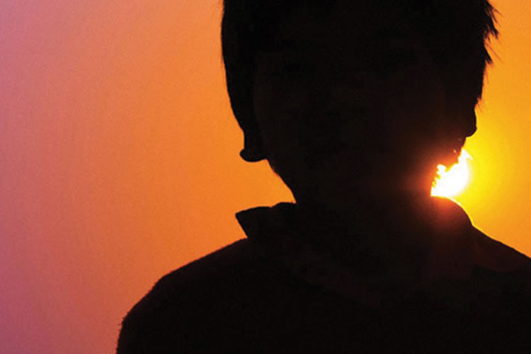 Kid standing in silhouette